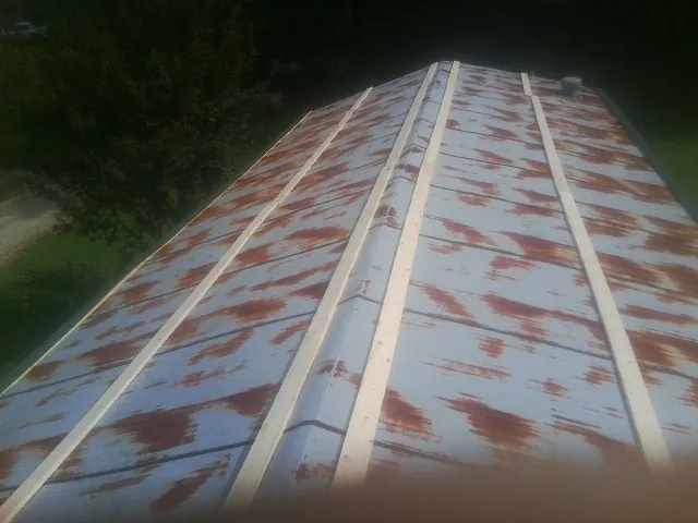 Rusted metal roof panels with new wood purlins before replacement — Storm Damage Roof Repair in Kennedyville by Roofing Brothers